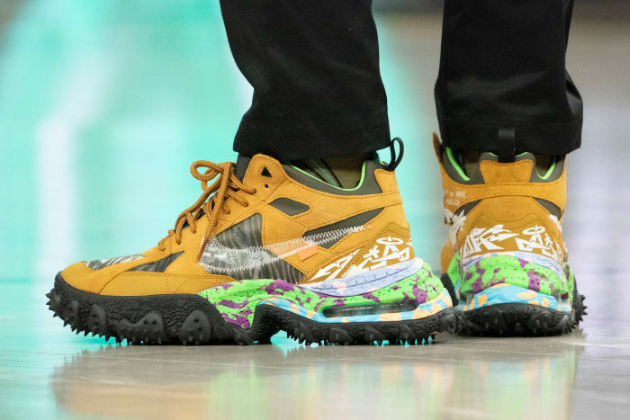 View of tan and black Nike shoes.